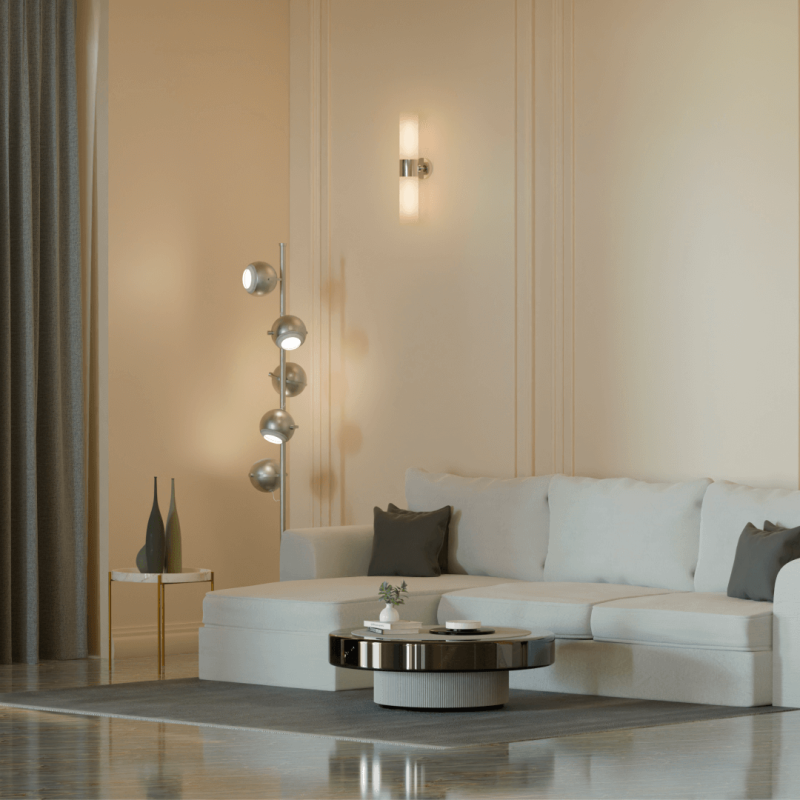 Modern beige living room with L-shaped sectional sofa, floor lamp, indoor plants, and minimalist wall decor